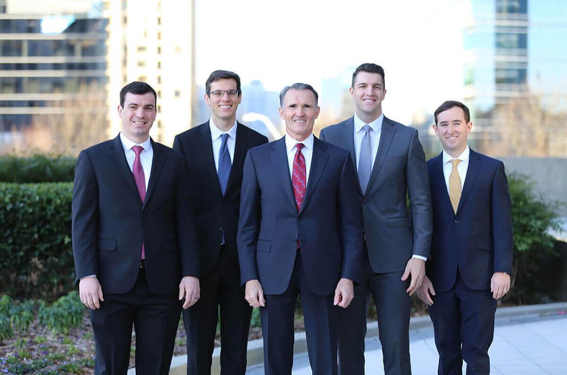 Smith Captial Advisors team photo in front of a city skyscraper